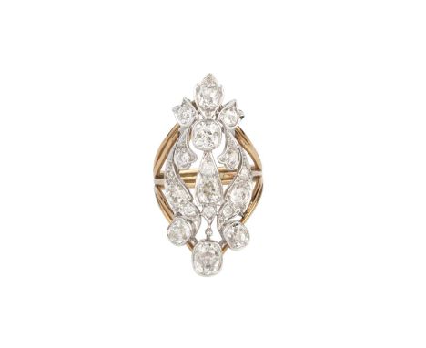 A diamond panel ring, the openwork foliate panel of graduated cushion-shaped old-cut diamonds spaced by smaller old-cut diamo