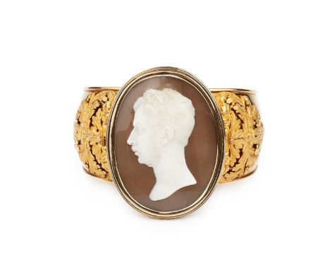 A mid 19th century cameo bangle, the oval shell cameo carved to depict the portrait profile of a bearded gentleman, signed Sa
