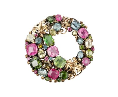 An Arts and Crafts vari gem-set brooch attributed to Dorrie Nossiter, designed as a wreath of vari-cut gemstones in shades of