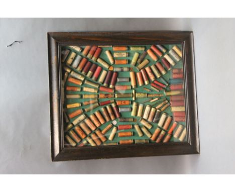 *  An ammunition display board, to include 8 bore, 32 Rimfire hinged for easy access,  64 x 54 cm.  SHOTGUN CERTIFICATE REQUI
