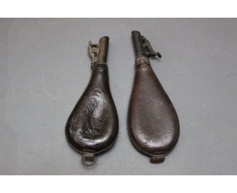 *  Two leather bodied shot flask, one embossed with hanging game, 21 cm and 23 cm excluding hanging loops.