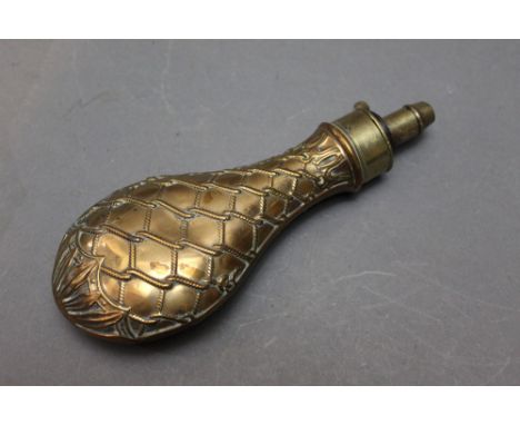 *  A copper bodied powder flask with net design, length 21 cm.