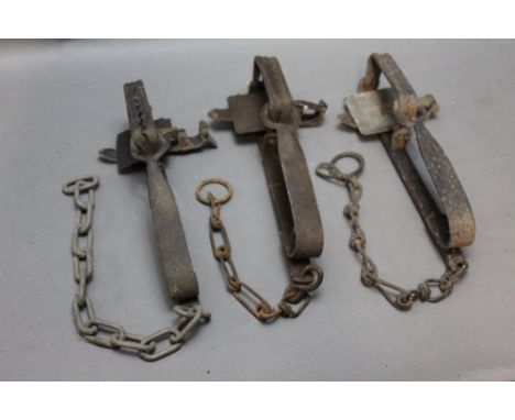 *  Three vintage gin traps, one stamped Lewis.