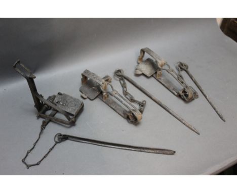 *  Two gin traps and another vintage trap, one gin marked with a Registered Design No. 695967.