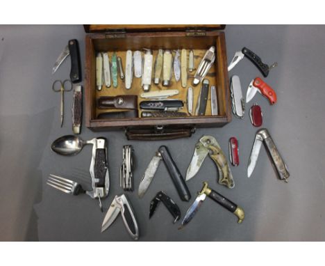 A box containing +/- thirty five folding pocket knives, scissors etc, to include Victorinox (Swiss Army knife), an example wi