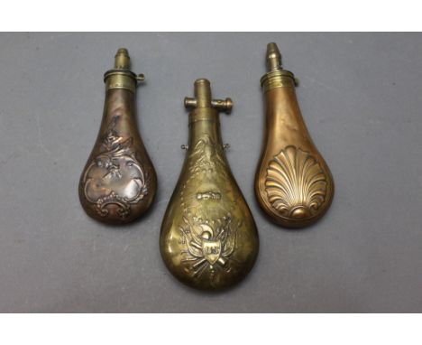 *  Three powder flasks, one stamped US in a shield with eagle and clasped hands, length 23 cm, also marked Batty, a flask wit