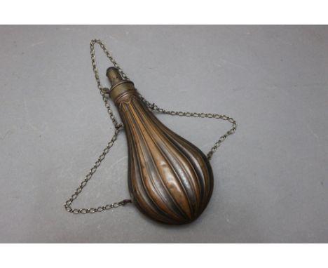 *  A.M. Flask &amp; Cap Company, a large powder flask with fluted body with hanging chain, length 24 cm.