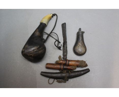 *  A collection of powder and shot flasks, to include a scrotum type and a small pistol flask.  Length 11 cm.