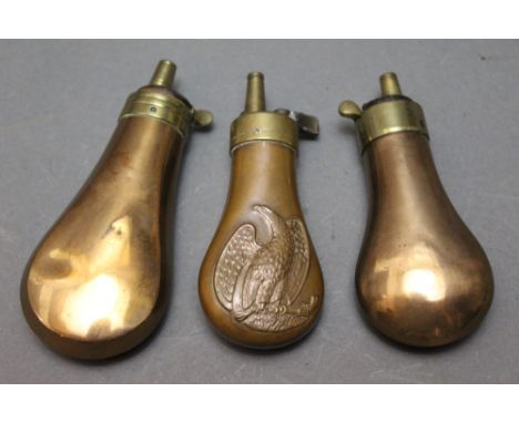 *  An eagle and revolver embossed pistol flask 11 cm, together with two plain bodied flasks 11 cm and 12 cm.