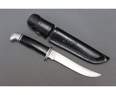 A Buck model 121 fixed blade knife, having a 5 1/2" blade.  Overall length 24.5 cm.