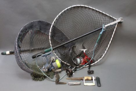 Two landing nets, together with a Mitchell 499 reel, a Shakespeare Firebird 070 reel, a part multiplier and three knives.  To