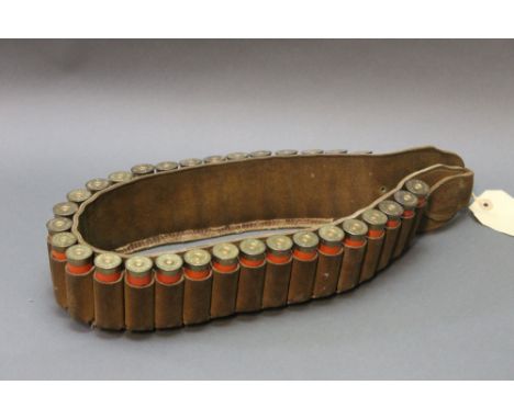 A leather cartridge belt containing 31 Eley Grand Prix and Eley Grand Prix waterproof 12 bore shotgun cartridges, various siz