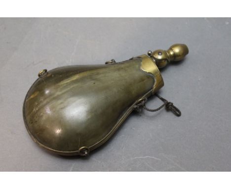*  A pressed horn bodied powder flask, with unusual folding brass nozzle, height when open 20 cm.