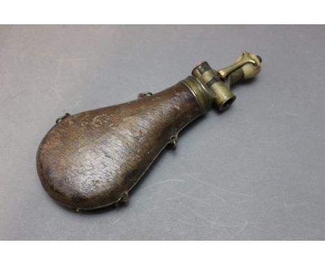 *  An unusual flask with a horn topped spring pump charger, the flask with leather covered body, length 24 cm.