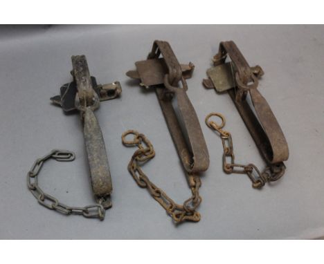 *  Three vintage gin traps, one stamped Daniel.