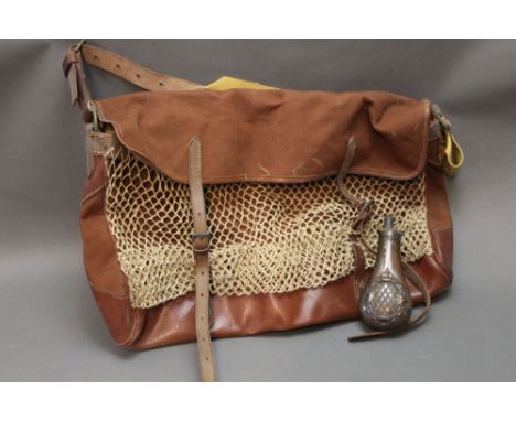 A canvas and leatherette game bag, together with a copper powder flask.  Flask length +/- 16 cm.