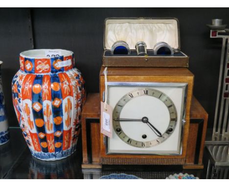 An Art Deco mahogany mantel clock, angular, square shape with silvered chapter ring, with key and pendulum, 10.5in. wide, tog