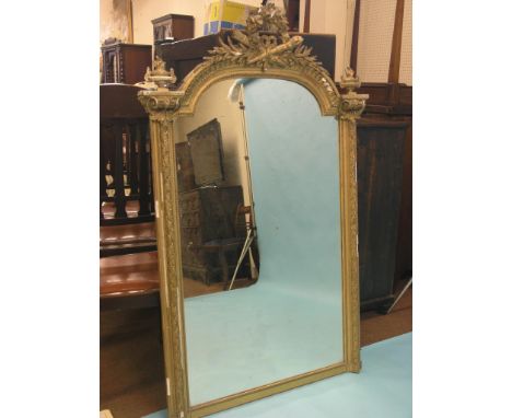 A 19th century moulded gilt mirror in neo-classical style, domed-shape with quiver and torch cresting, urn surmounts, 4ft. 10