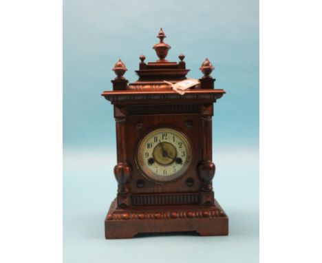 A late 19th century Black Forest mantel clock, in architectural walnut case, with key and pendulum, 17in., and three various 