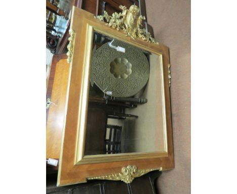 A large mid-18th century style mirror, rectangular with cartouche, ribbon and foliate cresting, mahogany veneered with parcel