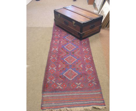 A metal-bound beech cabin trunk, on casters, 2ft. 9in., together with an Eastern-style wool runner, geometric designs in crim