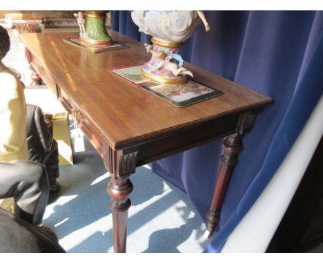 A late Victorian mahogany serving table, rectangular with two frieze drawers, on turned, tapering legs with ceramic casters, 