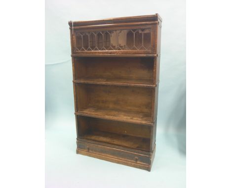 A Globe Wernicke dark oak bookcase, four sections, single base drawer, 2ft. 10in. - three doors lacking; one glass pane damag