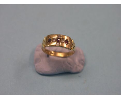 An 18ct. gold half-hoop ring, set ruby and diamond chips, size O