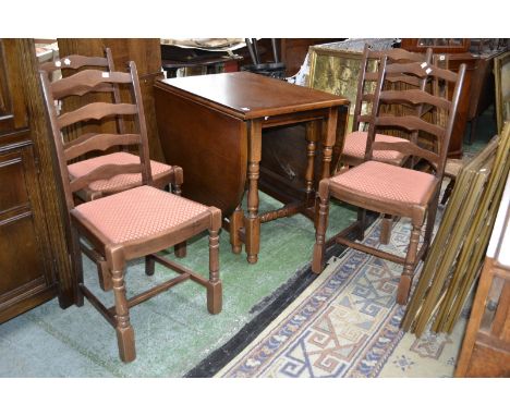 An oak dropleaf table and four oak ladder back dining chairs