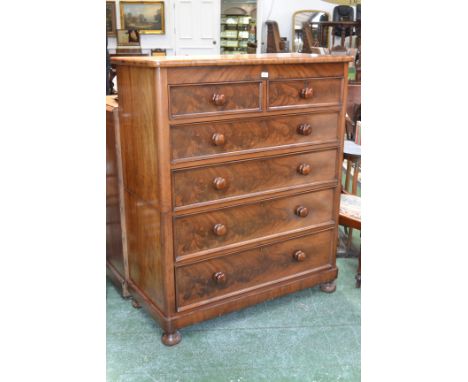 A Victorian mahogany chest of drawers, oversailing top, two short drawers over four graduated long, button handles, bun feet,
