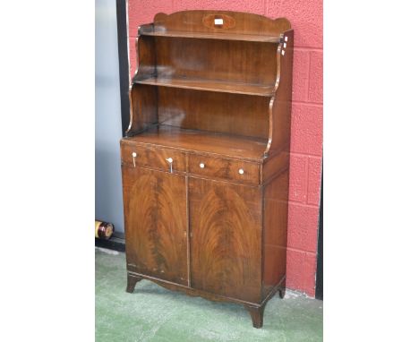 A 19th century mahogany waterfall bookcase cabinet, shaped gallery with flame mahogany cartouche. shaped uprights and two she