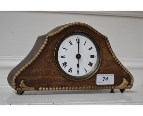 An Art Nouveau oak mantel clock, white enamel dial painted with Roman numerals
