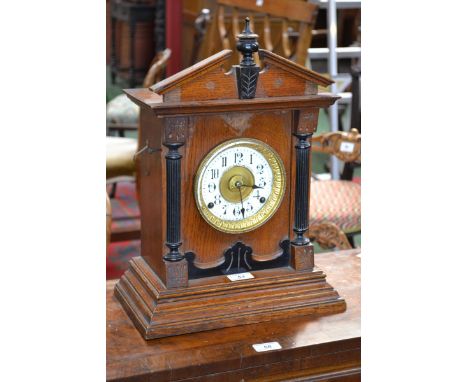 A 20th century oak mantel alarm clock, Fattorini & Sons, Bradford, architectural pediment painted chapter ring, Arabic numera