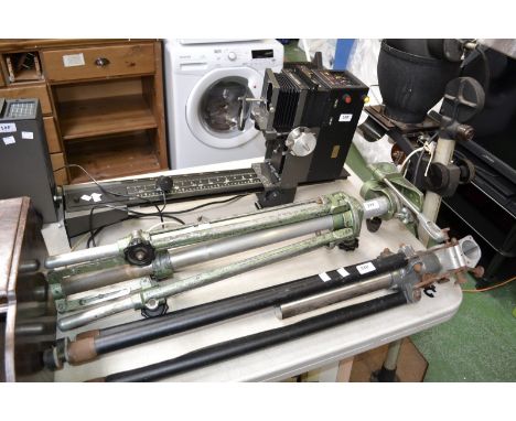 A Durst M605 photograph enlarger; a Durst M370BW photograph enlarger; a vintage enlarger and two tripod stands, one by Devere