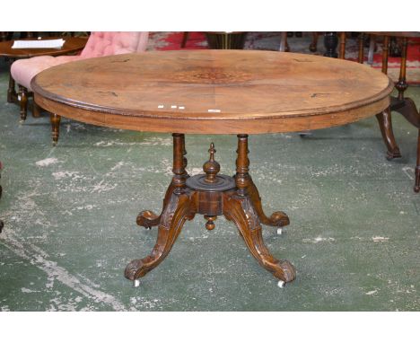 A Victorian walnut loo table, quarter veneered oval top inlaid with satinwood and boxwood flora and swags, four turned column