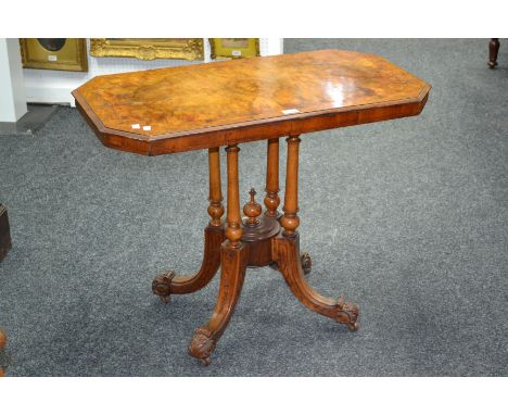 A Victorian burr walnut quarter veneered table, canted rectangular top supported by four turned columns, under finial, sabre 