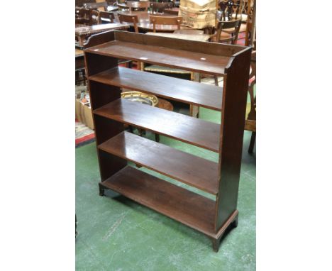A 19th century mahogany open bookcase, outlined with ebony stringing, outswept bracket feet