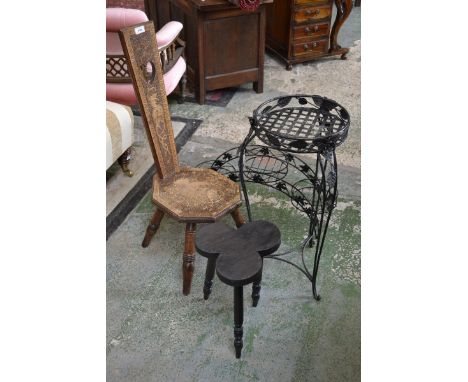 A novelty stool, the seat as a clover leaf; a wrought iron jardiniere stand, applied with roses; conforming three-section arc