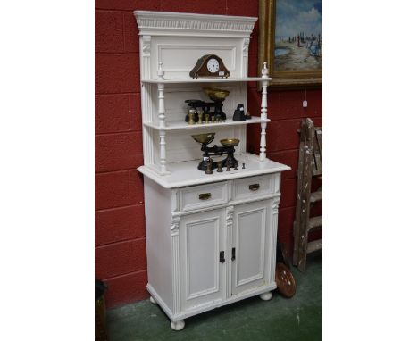 A Victorian painted pine dresser of small proportions two shelves supported by columns, two short drawers over two panel door