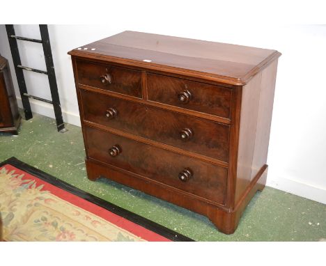 A Victorian mahogany chest, moulded oversailing top, above two short and two long graduated cock beaded drawers, turned woode
