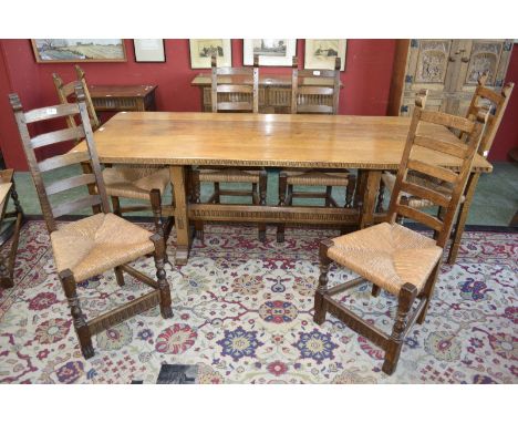 An oak Rupert Griffith refectory table, plank top and six Rupert Griffith oak ladder back chairs with raffia seats. (7)