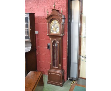 A modern mahogany long case clock, pagoda top to hood supported on brass tipped fluted columns, arched brass dials, cast span