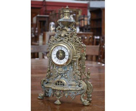 A brass cased rococo style mantel clock, Roman numerals, later movement.