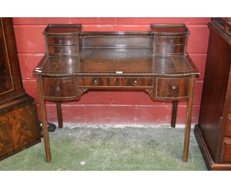 A mahogany clerk's desk, four short drawers and shelving to superstructure, leather inlaid writing surface, inverted breakfro