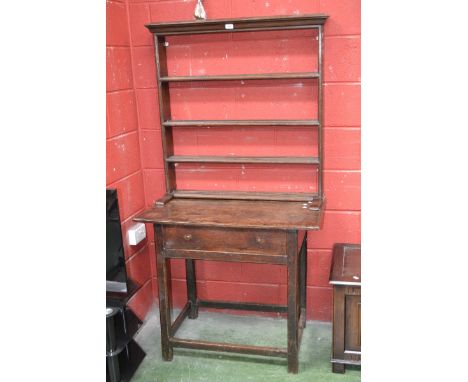 An oak lowboy circa 1800 with later four shelf dresser back. 174cm high x 92cm wide x 53cm deep.