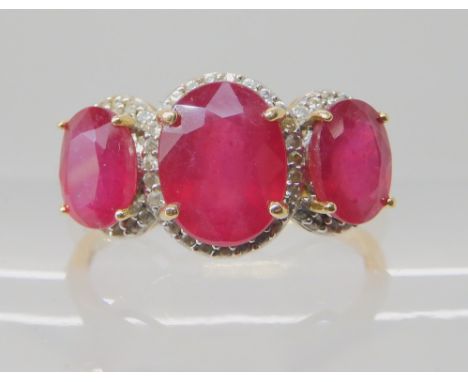 A 9ct yellow gold enhanced ruby trilogy ring, size S1/2, weight 3.1gms Condition Report: Available upon request