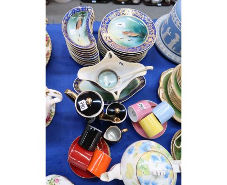A Meito China fish set, painted with fish and signed H Ichikawa, comprising eleven plates and ten crescent shaped plates, sau