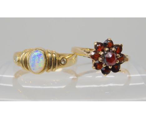 A 9ct gold opal and diamond ring size P1/2, and a 9ct gold garnet cluster ring size O1/2, weight together 4.4gms Condition Re