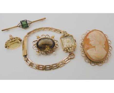 A 9ct cameo brooch 4.2cm x 3.6cm, a 9ct green gem brooch, a yellow metal smoky quartz and pearl brooch, 9ct citrine fob weigh