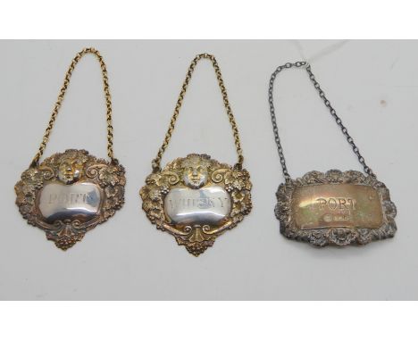 A lot comprising a pair of silver decanter labels, Port and Whisky, London 1906 and a single Port, Sheffield 1986 (3), 60gms 